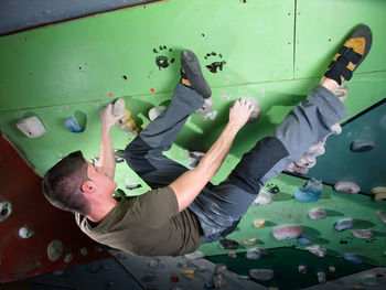 Young man on climbing wall