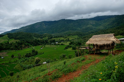 Scenic view of field and mountains against sky