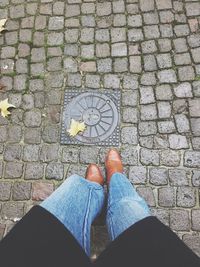 Low section of man standing on footpath