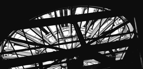 Low angle view of silhouette ferris wheel against sky