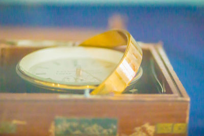 Close-up of clock in glass on table