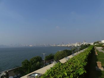 High angle view of buildings and sea against sky