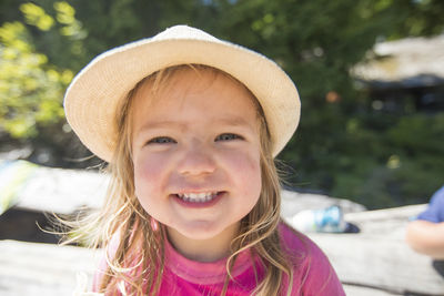 Portrait of cute young girl wearing sun hat at the beach