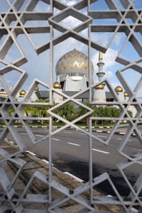 Metallic structure with fence in background