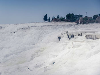 Scenic view of land against clear sky during winter