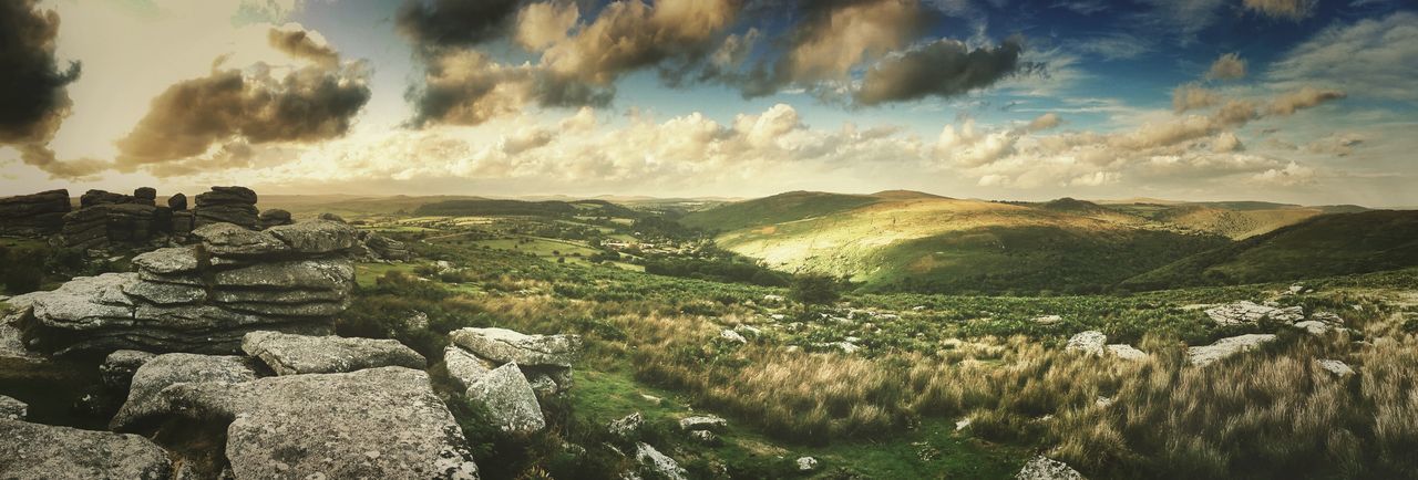 sky, cloud - sky, scenics, landscape, tranquil scene, tranquility, nature, beauty in nature, cloudy, rock - object, high angle view, mountain, cloud, water, built structure, day, outdoors, idyllic, non-urban scene, rock formation