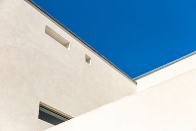 Low angle view of built structure against clear blue sky