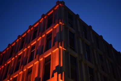 Low angle view of illuminated building against sky at night