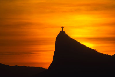 Silhouette of temple against sky during sunset