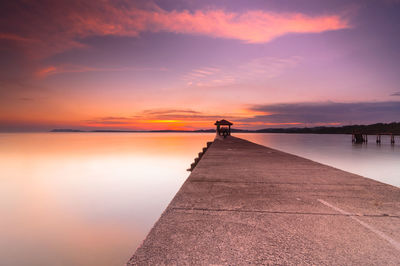 Surface level of pier against calm sea at sunset in port dickson, malaysia