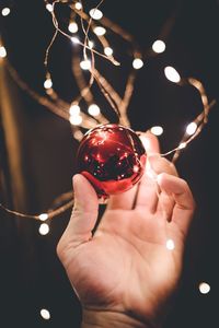 Close-up of hand holding christmas bauble