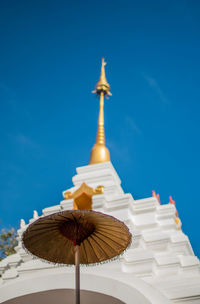 Low angle view of traditional building against blue sky