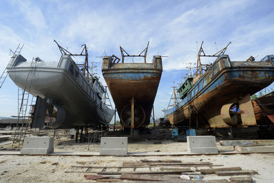 Ships at yard against sky