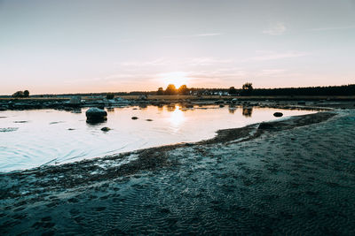 Scenic view of lake against sky during sunset