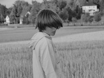 Rear view of woman standing on field