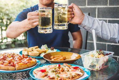 Midsection of man having food on table