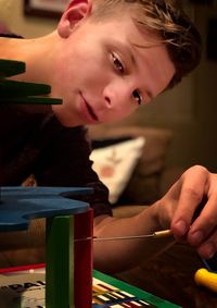 Close-up of teenage boy playing game on table