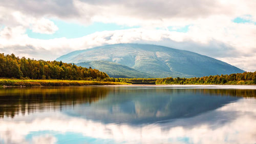 Scenic view of lake and mountains against sky