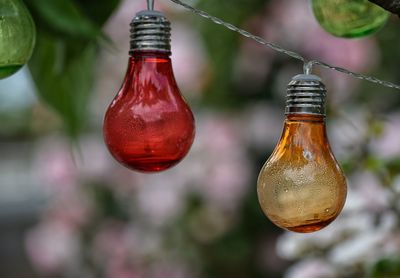 Close-up of red bottle hanging outdoors