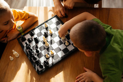 High angle view of boys playing on table