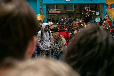 Rear view of people walking on street