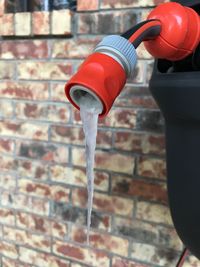 Close up of red pipe with frozen water