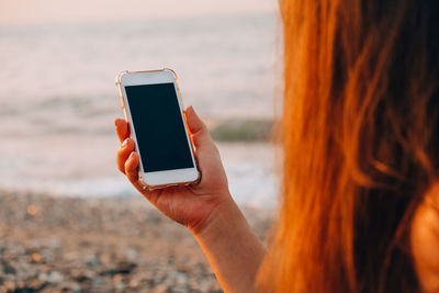 Midsection of man using mobile phone