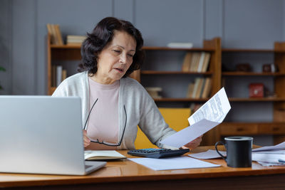 Young woman using laptop at table