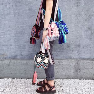 Low section of young woman standing on cobblestone street with bags