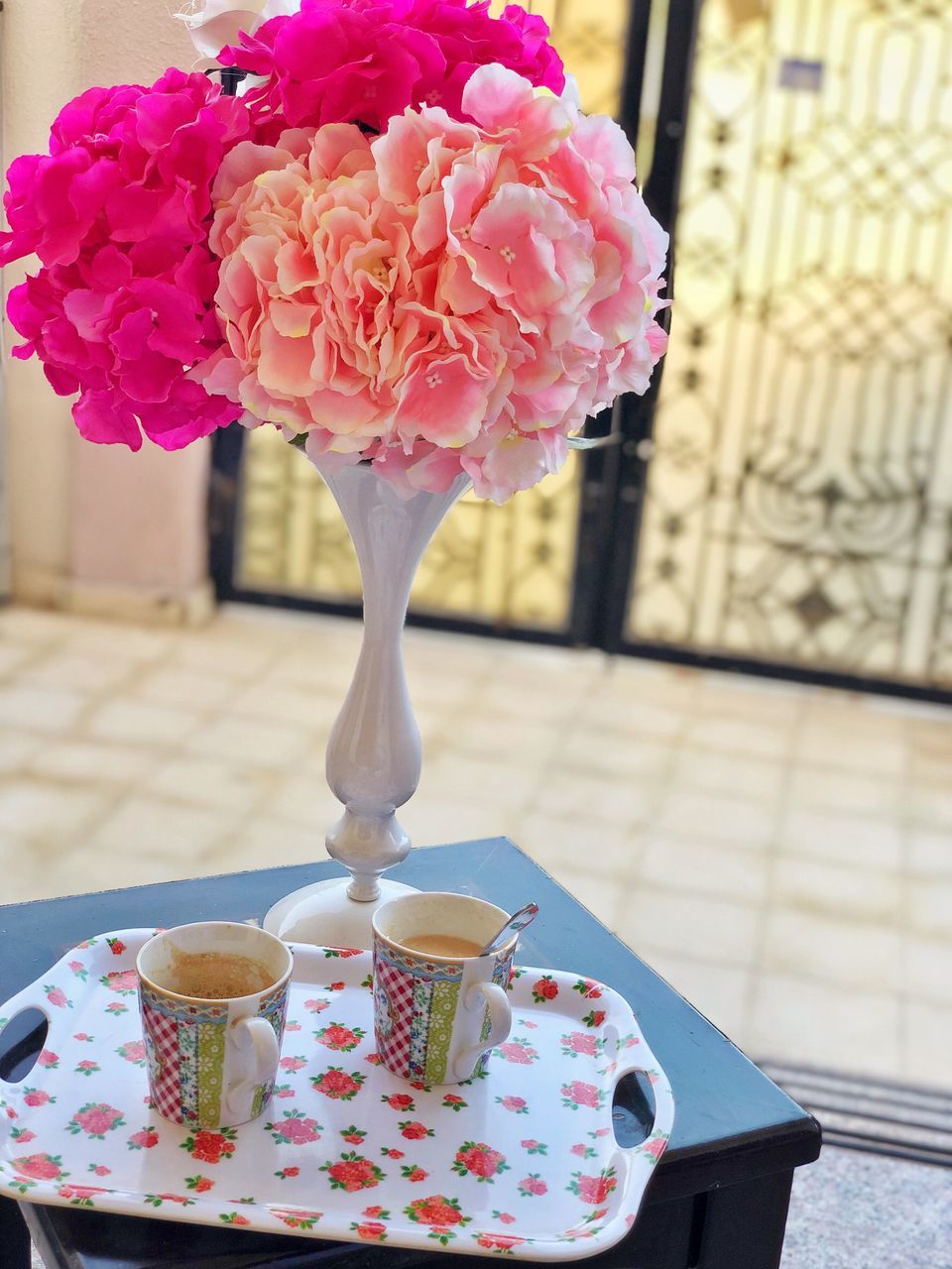 CLOSE-UP OF PINK ROSE IN VASE