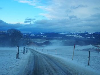 Scenic view of snow covered landscape against sky