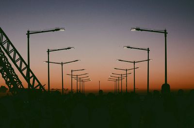 Silhouette field against clear sky during sunset