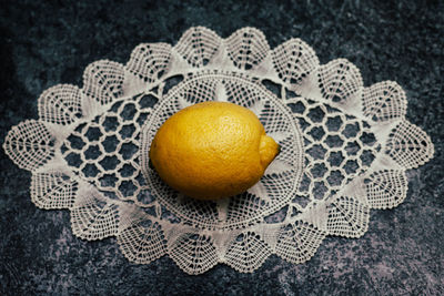 Close-up of lemon with fabric on table