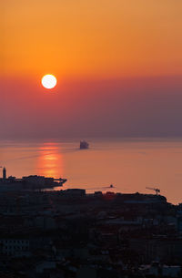 Scenic view of sea against orange sky