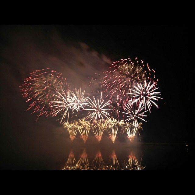 night, firework display, illuminated, exploding, arts culture and entertainment, sky, long exposure, firework - man made object, celebration, sparks, motion, glowing, low angle view, blurred motion, firework, event, entertainment, water, outdoors, multi colored