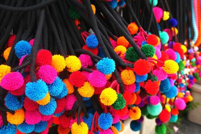 Close-up of colorful woolen decorations for sale at market stall