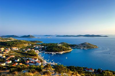 High angle view of bay against clear blue sky