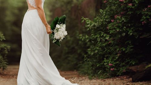 Close-up of woman holding white flower