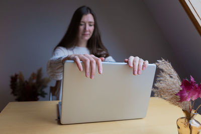 Portrait of young woman using a laptop