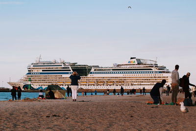 People on beach against sky