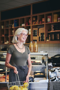 Woman standing by food in restaurant