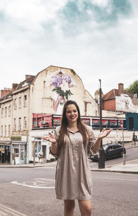Portrait of a smiling young woman standing on street