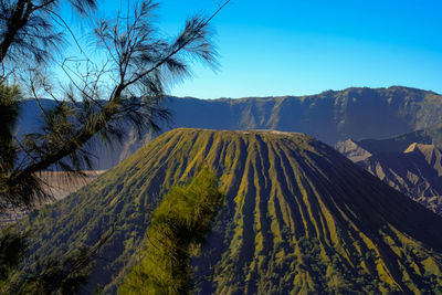 Scenic view of mountains against clear blue sky