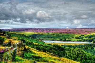 Scenic view of landscape against cloudy sky