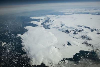 Aerial view of snowcapped landscape against sky