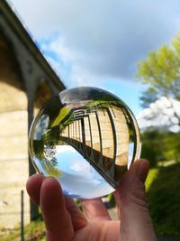 Close-up of hand holding crystal ball