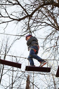 Low angle view of child on playground during winter