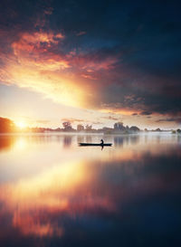 Scenic view of lake against sky during sunset