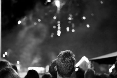 Rear view of head of man watching performance