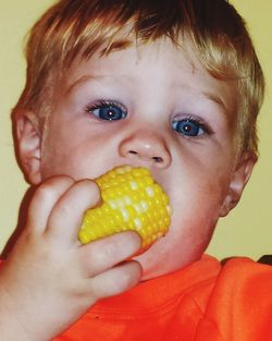 Close-up portrait of cute boy eating food